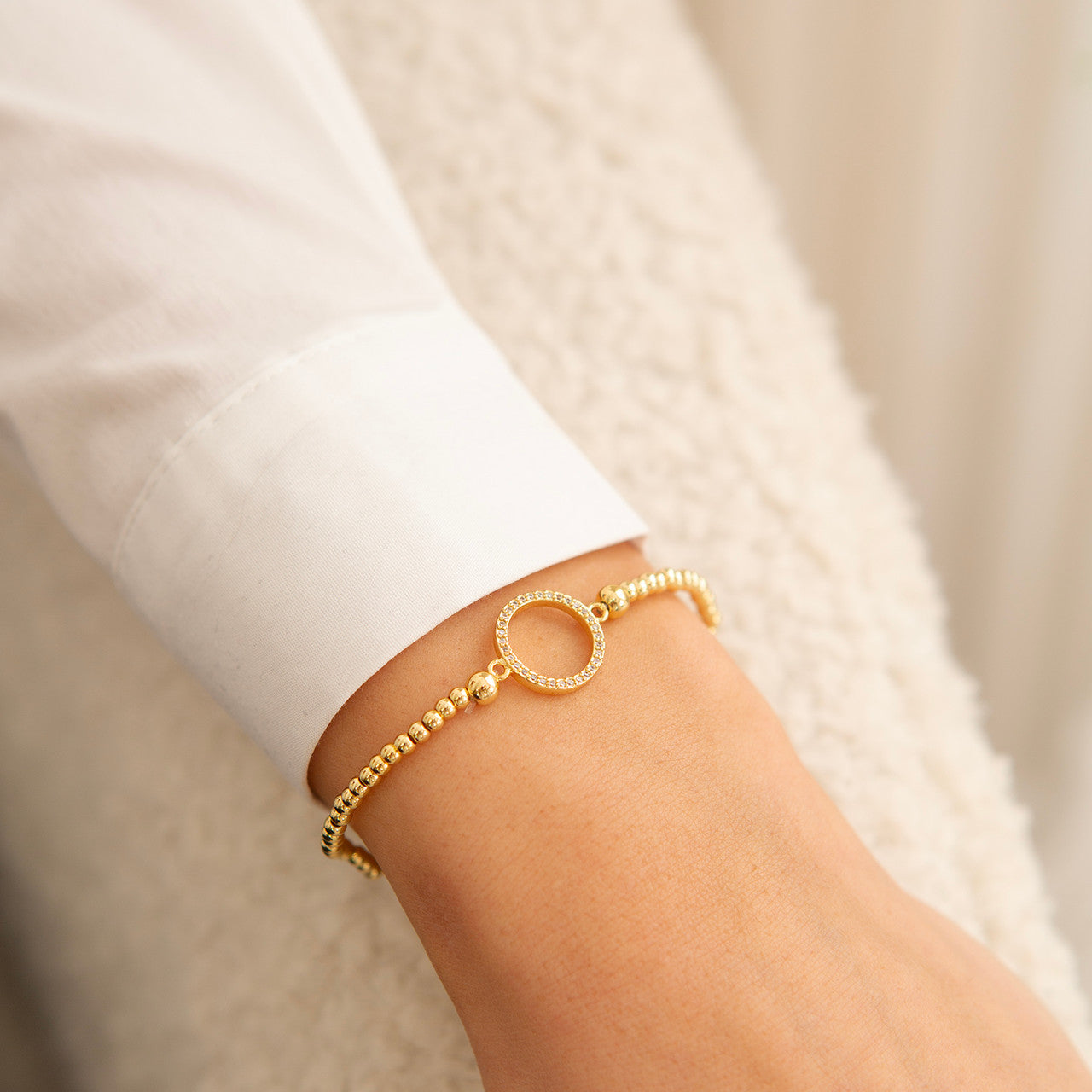 Open crystal circle bracelet in gold